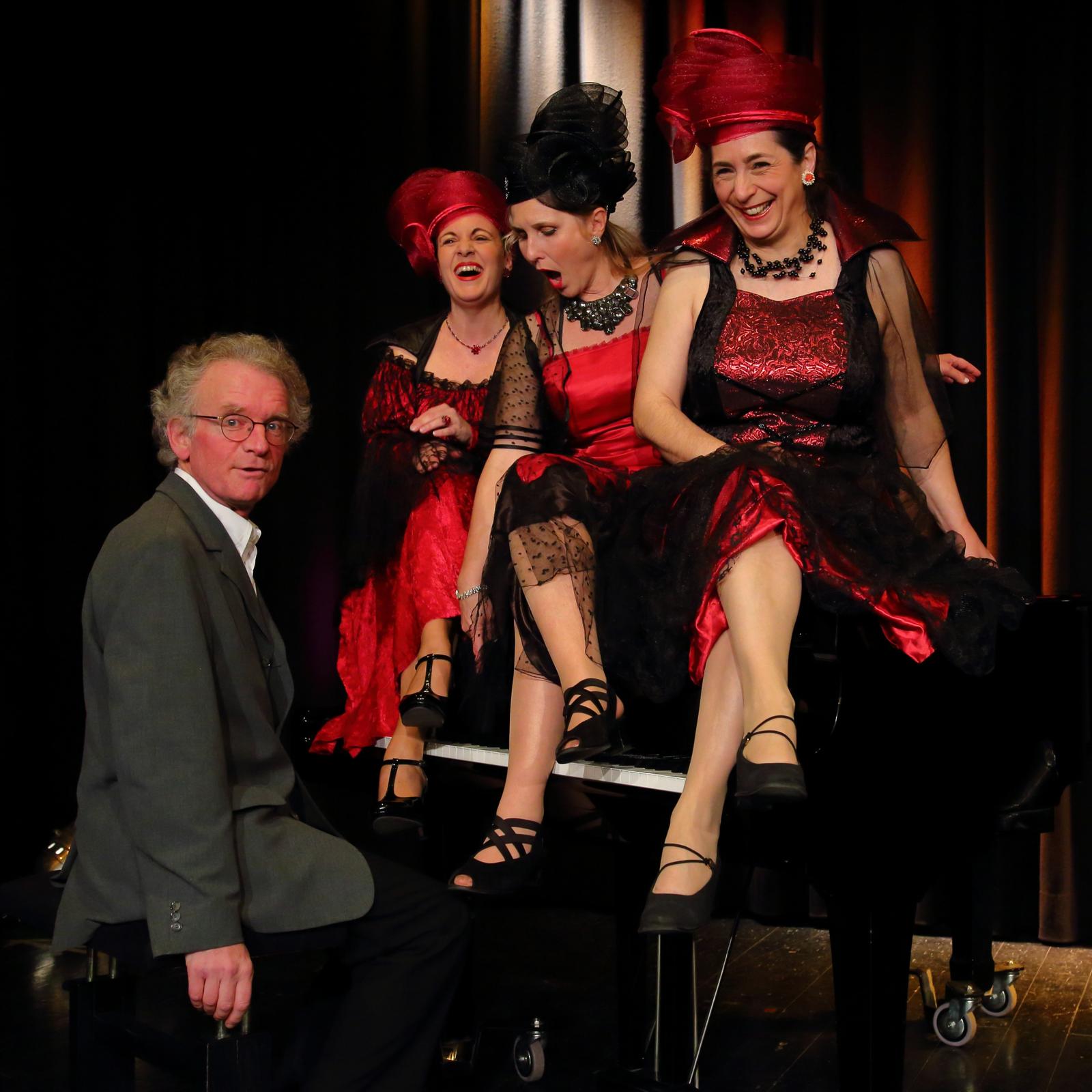 Marion Neuendorf mit Ensemble bei Die Fräuleins – rot-schwarze Bühnenkostüme